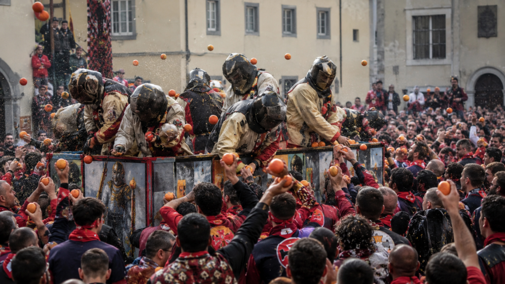 İtalya Ivrea Portakal Savaşı festivalinde portakal atan kalabalık